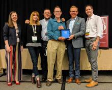 PlanCOS team holding award